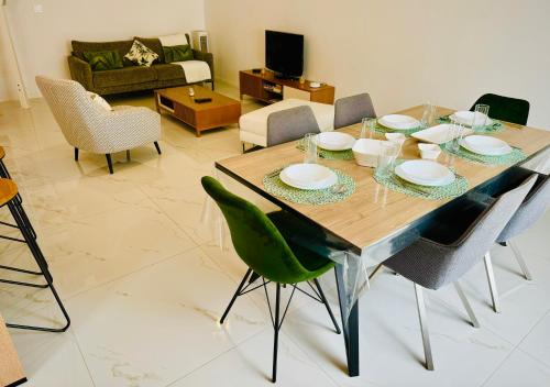 a dining table and chairs in a living room at Appartement Premium 4 Stars - Antigone in Montpellier