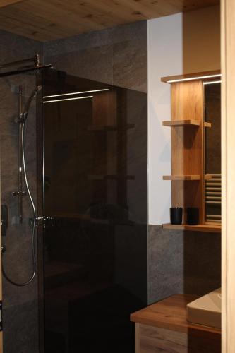 a bathroom with a shower and a sink at Ferienhaus & -wohnung Flatscher in Waidring