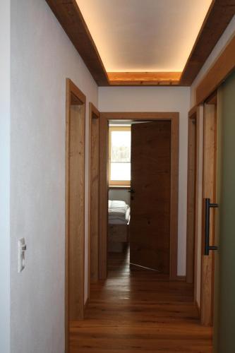 a hallway leading to a room with a door at Ferienhaus & -wohnung Flatscher in Waidring