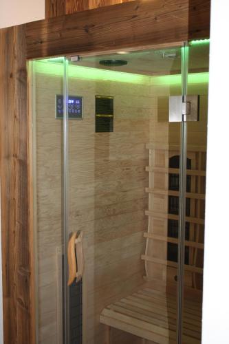 a walk in shower with a bench in a room at Ferienhaus & -wohnung Flatscher in Waidring