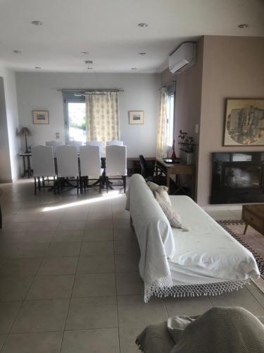 a living room with a bed and a table and chairs at Aegean Blue Villa in Mytilene