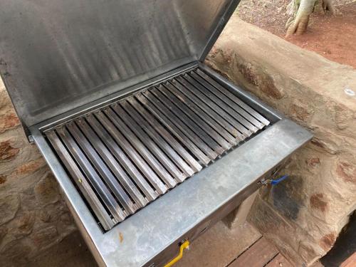 a metal grill sitting on top of a table at Soetvlei Tented Farm Camp in Magaliesburg