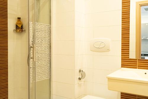 a bathroom with a shower and a sink at Best Residence Rin Grand Hotel in Bucharest