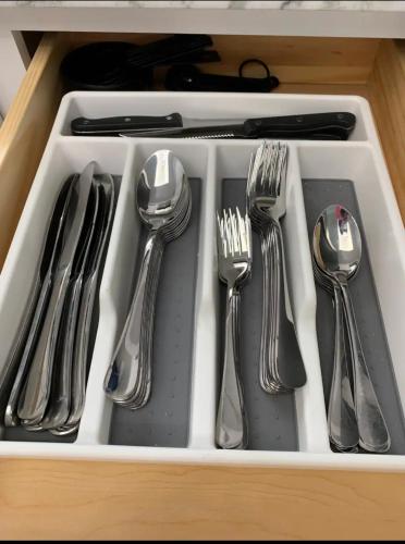 a drawer filled with silver utensils in a drawer at Placeforus in Brooklyn