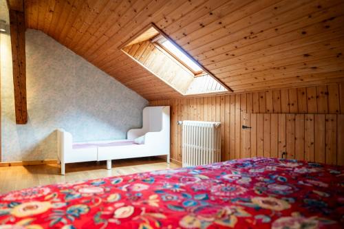 a bedroom with a large bed and a window at Gite des Rousses d'Amont - 15 personnes in Les Rousses