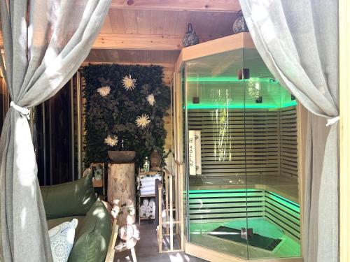 a living room with a glass window and a couch at Les Gîtes et la Chambre de Labahou SPA in Anduze