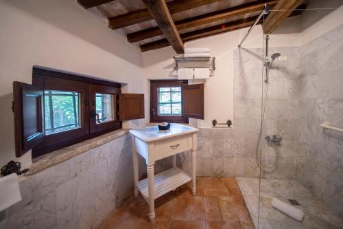 a bathroom with a sink and a shower at La Maestà antica dimora di campagna in Foligno