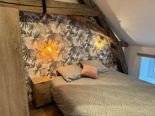 a bedroom with a canopy bed with two pillows at Logement cocon in Chaudenay