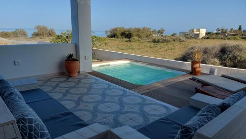 a patio with a swimming pool on a house at Sea breeze houses in Monolithos