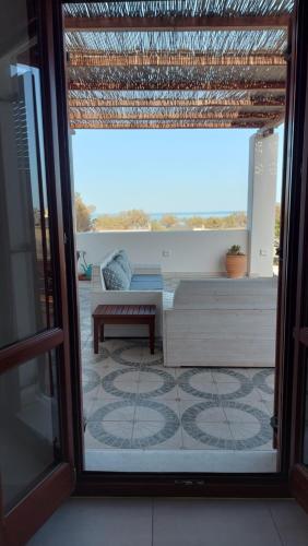 a view of a living room through a sliding glass door at Sea breeze houses in Monolithos