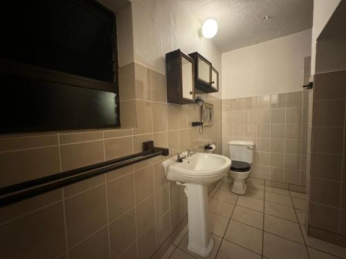 a bathroom with a sink and a toilet at Chandos Apartment Vleesbaai in Vleesbaai