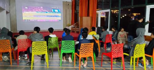 a group of people sitting in chairs in front of a screen at The Himalaya Retreat Resort, Experience Nature in the Lap of Himalayas in Mussoorie