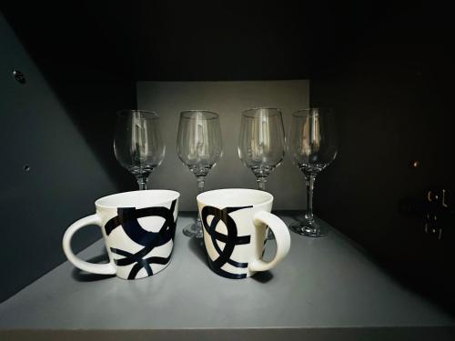 a table with two coffee cups and wine glasses at Blok in Sajmište