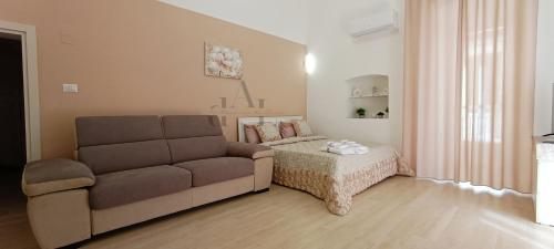 sala de estar con sofá y mesa en de Lucia Affittacamere - Elegante appartamento storico nel cuore della città, en Terlizzi