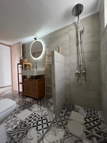 a bathroom with a sink and a toilet and a mirror at Aegina seaview home in Aegina Town