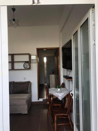 a living room with a table and a couch at Xaxa Apartments in Ulcinj