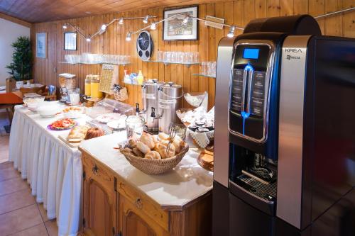a kitchen with a counter with a table with bread at Hotel Tautermann in Innsbruck