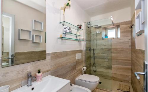 a bathroom with a shower and a toilet and a sink at Viareggio sul Mare in Viareggio
