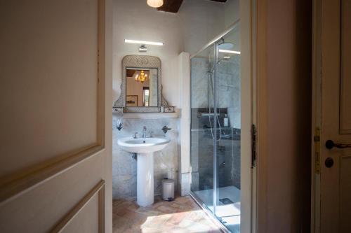 a bathroom with a sink and a shower at La Maestà antica dimora di campagna in Foligno