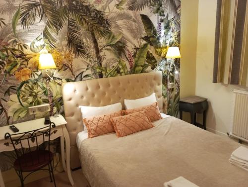 - une chambre avec un lit et un mur orné de plantes dans l'établissement Logis Hôtel Louise de Savoie, à Blois
