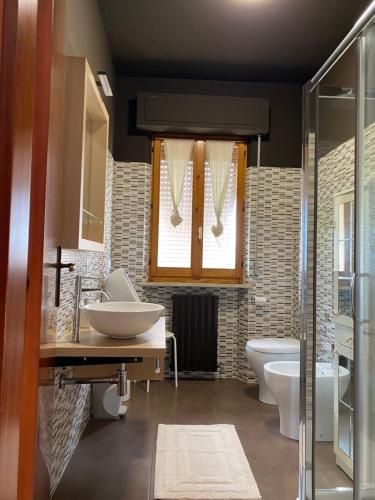 a bathroom with a sink and a tub and a toilet at B&B IL QUADRIFOGLIO in Iesi