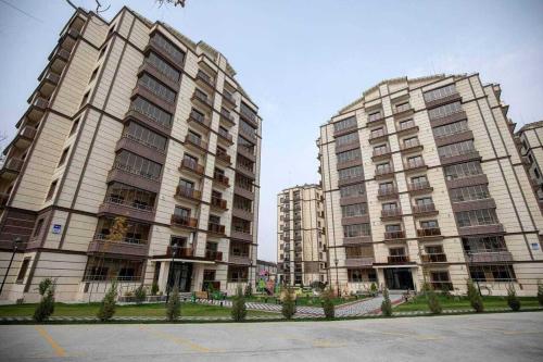 two large tall buildings next to a parking lot at Lux Istanbul City in Yakkasaray