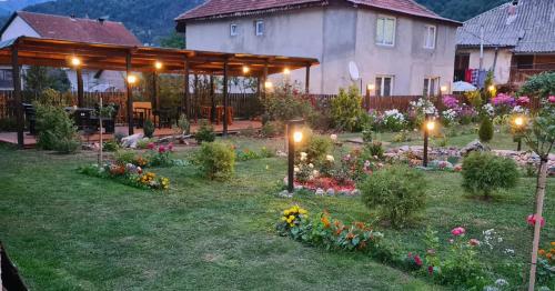 a garden in front of a house with lights at Black Tower in Plav