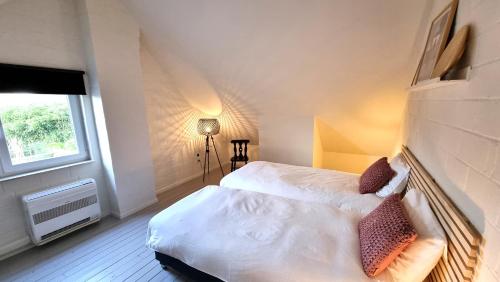 a bedroom with a bed and a window at Casa Rosalie in Lokeren