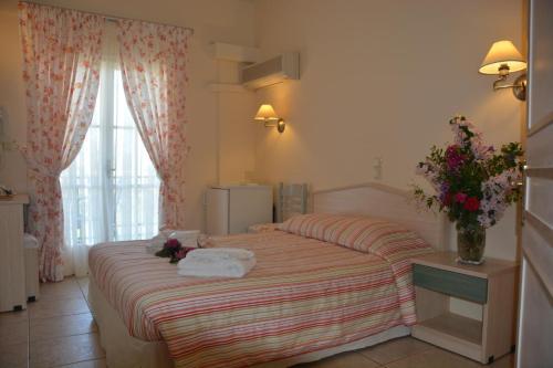 una camera d'albergo con un letto fiorito di Starlight Hotel a Skala di Cefalonia