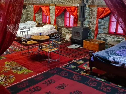 a bedroom with a bed and a table and a stove at Black Tower in Plav