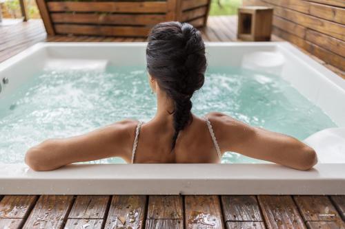 a woman sitting in a jacuzzi tub at Eco Hotel Oceanomare in Florianópolis