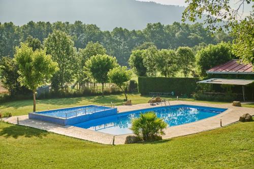 an image of a swimming pool in a yard at Camping-Bungalow la Vall de Campmajor in Sant Miquel de Campmajor