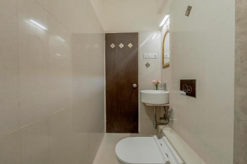 a bathroom with a toilet and a sink at Bellini, Anjuna, Goa, 5 Mins from Beach, Centrally Located in Anjuna