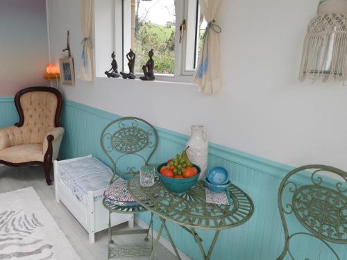 a room with a table with a bowl of fruit on it at Bayview Bed & Breakfast in Béal an dá Chab