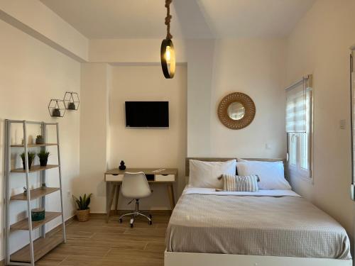 a bedroom with a bed and a desk at "Calm Joy & J" - Infinity in Ermoupoli