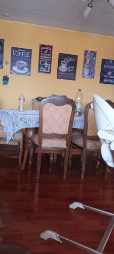 a dining room with a table and chairs and a surfboard at Dpto Empart 5 in Arica
