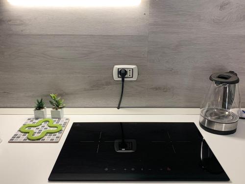 a kitchen counter with an electric outlet on a wall at Magda House & Parking in Bari