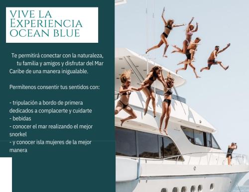 a group of girls jumping off a boat at Ocean Blue in Cancún