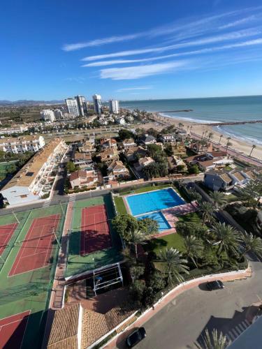 an aerial view of a resort and the beach at Bungalow on the beach 15 minutes from Valencia in Valencia