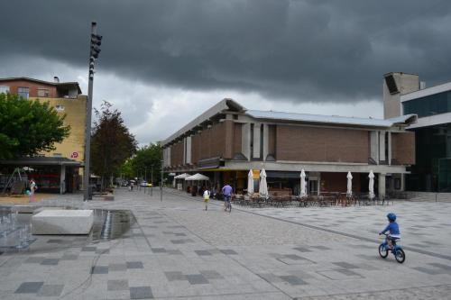 a boy riding a bike in front of a building at Love 2 Solkan in Nova Gorica