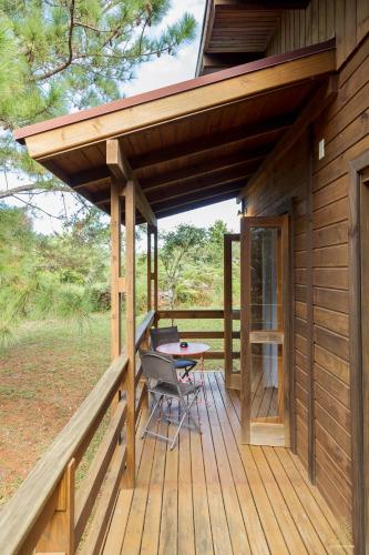a cabin with a table on a deck at Eco Hotel Oceanomare in Florianópolis