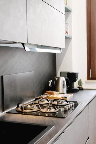 a kitchen with a stove top in a kitchen at Alivi Indipendent Apartment in Brindisi