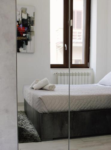 a bedroom with a bed with a glass wall at Alivi Indipendent Apartment in Brindisi
