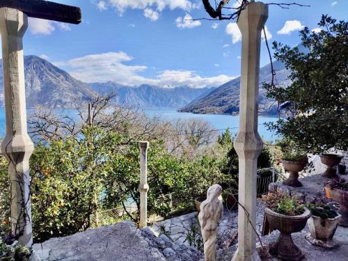 a statue of a dog in a garden with a view at Villa Terrazza in Donji Morinj
