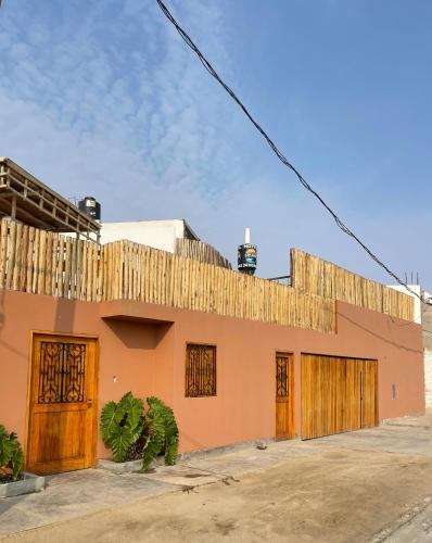 a building with a fence on top of it at El Templo Surf House in Punta Hermosa