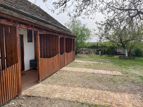 a barn with a wooden door next to a yard at Salaš Isailovi in Sremska Mitrovica