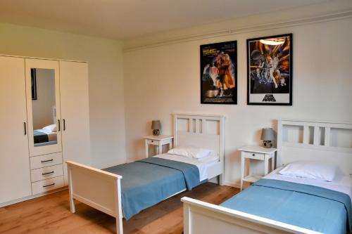 a bedroom with two beds and pictures on the wall at Vacation home Pula in Pula