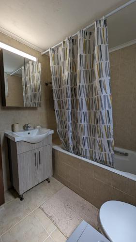 a bathroom with a sink and a tub and a toilet at GIANNIS HOUSE in Rhodes Town