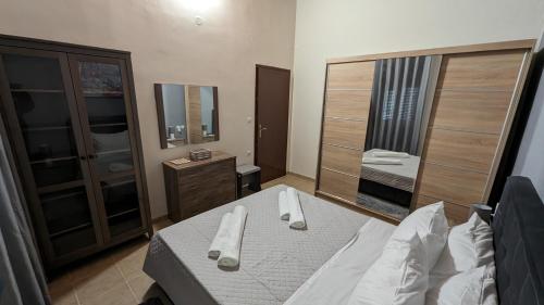 a small bedroom with a bed and a mirror at GIANNIS HOUSE in Rhodes Town