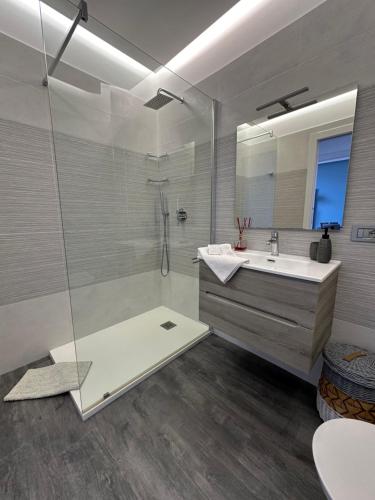 La salle de bains est pourvue d'un lavabo et d'une douche avec un miroir. dans l'établissement La Gaviota - Bilocale sul mare in Arziglia, à Bordighera